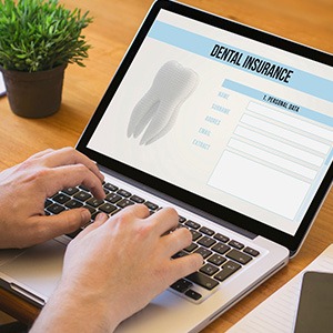 Patient filling out dental insurance form on computer
