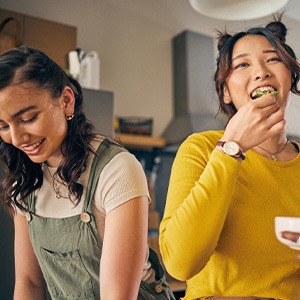 Group of friends smiling while enjoying meal together