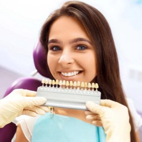 Young woman getting veneers from her dentist